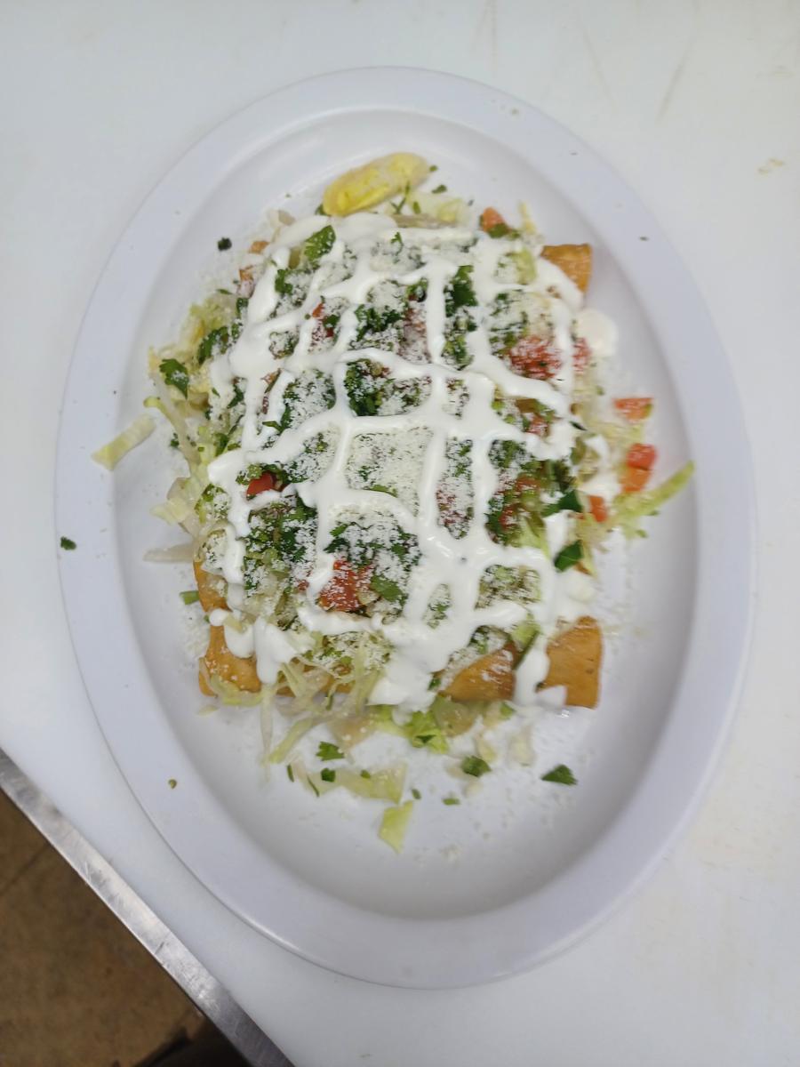 Flautas de Pollo - Crispy chicken and cheese flautas with salad and crema.